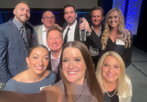 Clinicians in Dallas posing with healthcare award at recognition event.