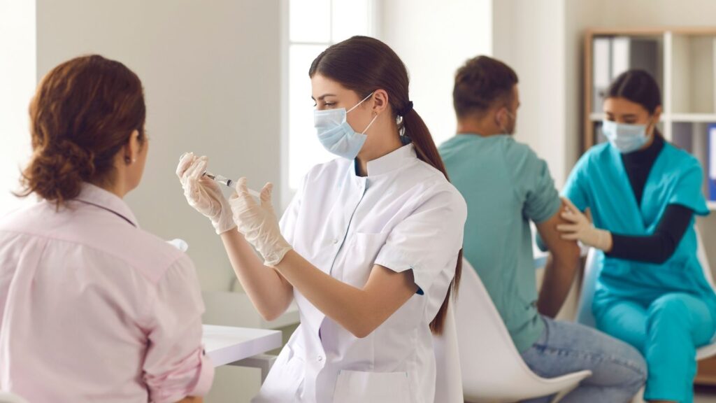 Travel Nurse prepping COVID-19 vaccine in a clinic.