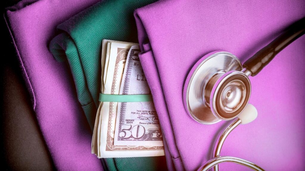 Pink scrubs with money tucked into the pocket.