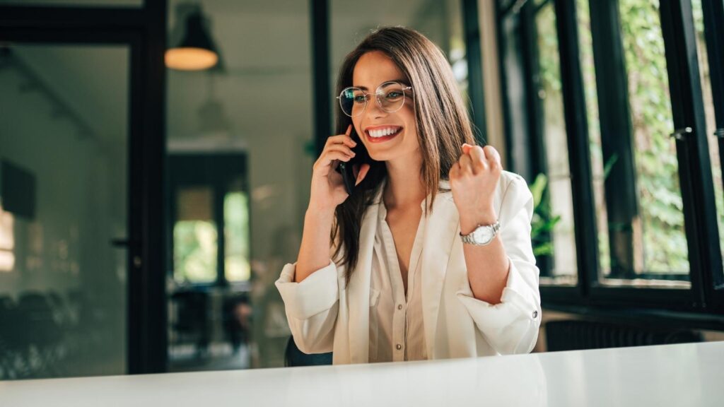 Woman with glasses on the phone with a recruiter.