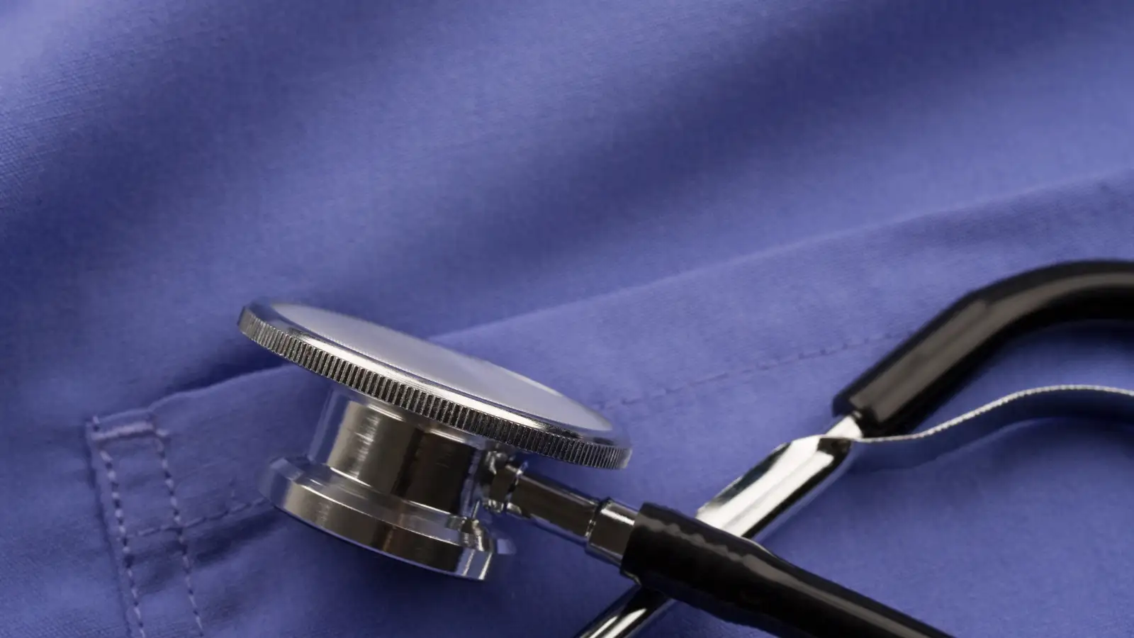 Travel nurse wearing blue Mandala scrubs, showcasing comfort and fit for Mandala scrubs review.