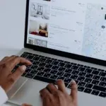 Travel nurse browsing travel nurse housing websites on a laptop