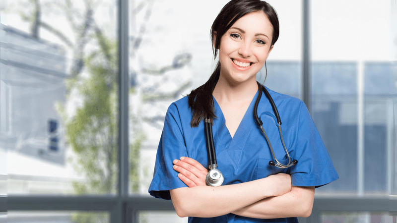 Smiling travel nurse checking her schedule and pay information